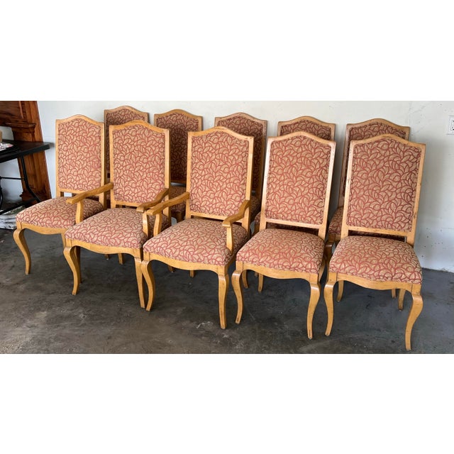 Set of 10 tall-back upholstered dining chairs in a traditional Old World style. Known for superior craftsmanship, Guy...