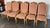 Set of 10 tall-back upholstered dining chairs in a traditional Old World style. Known for superior craftsmanship, Guy...