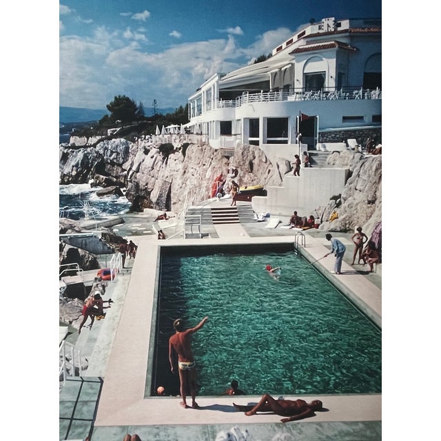 "Eden Roc Pool", French Riviera 1976, 40" x 60" C-Print by Slim Aarons A sun-drenched glimpse into the effortless glamour...
