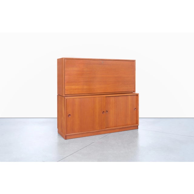 Designed by Borge Mogensen for Karl Andersson in the 1960s, this Swedish two-piece teak secretary cabinet embodies the...