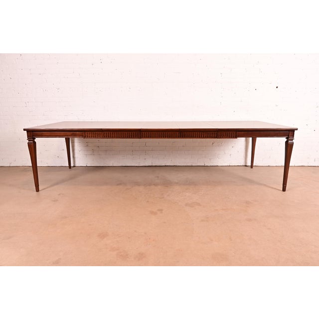 A gorgeous French Regency Louis XVI style extension dining table By John Widdicomb USA, Late 20th Century Beautiful carved...