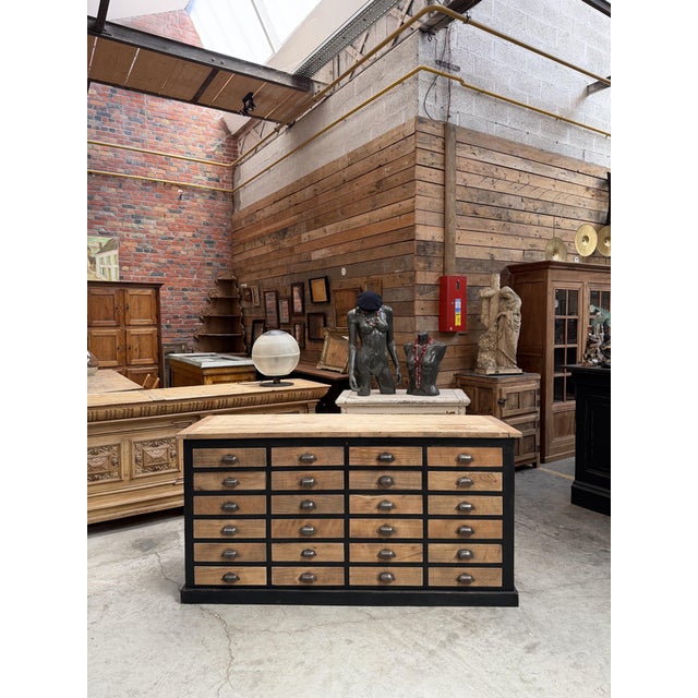 This antique workshop cabinet, made of beech and oak, has been fully restored. It features a black-patinated body. Its top...