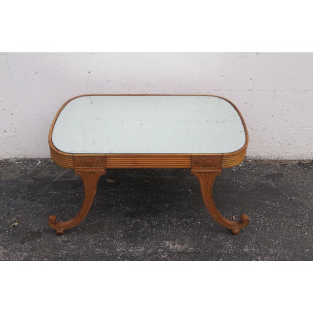 This Coffee Table is made out of wood, mirror, and it is in good condition. This classic Coffee Table is from the early...