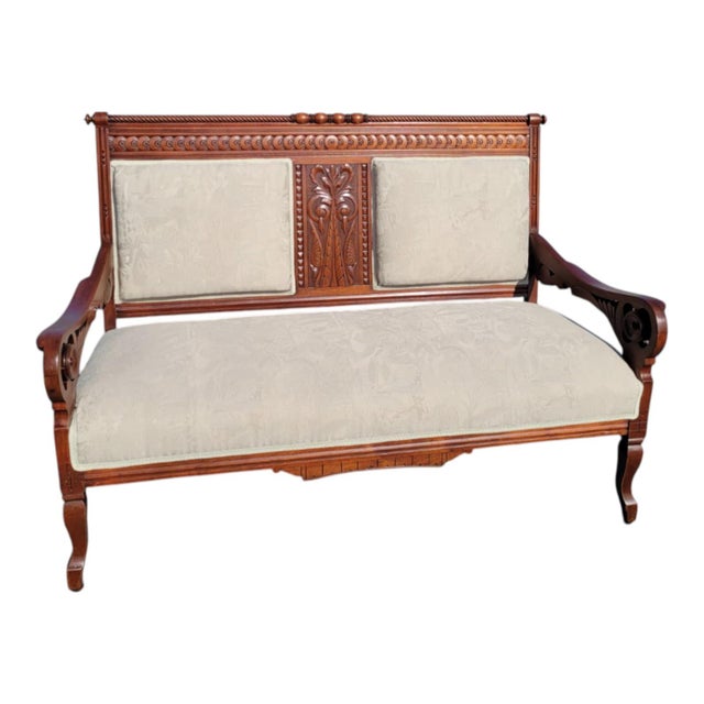 This exquisite 19th century Eastlake loveseat has been beautifully refinished and reupholstered. Crafted from solid...