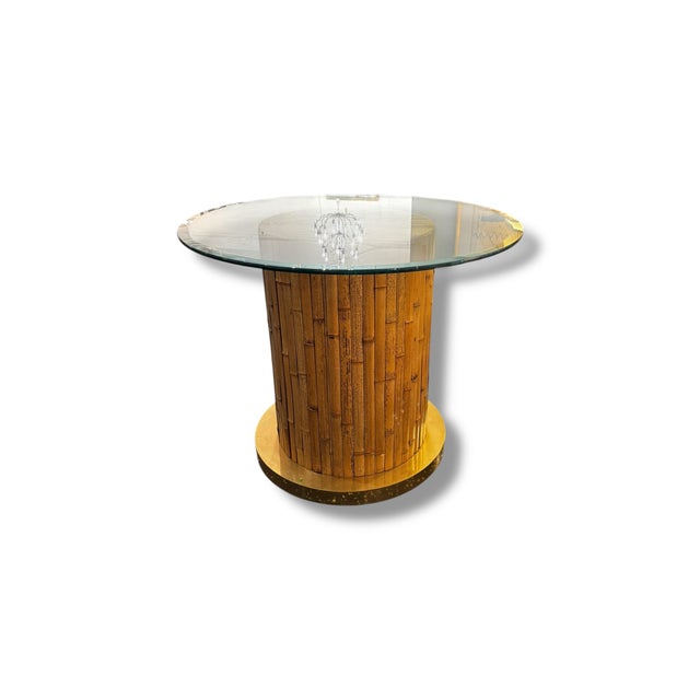 Striking vintage modern table featuring a sculptural faux bamboo pedestal base topped with a thick round glass surface and...