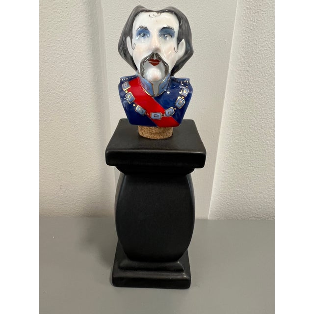 Very rare wine stopper made of porcelain that depicts an officer or nobleman. His uniform is blue and red with gilt...