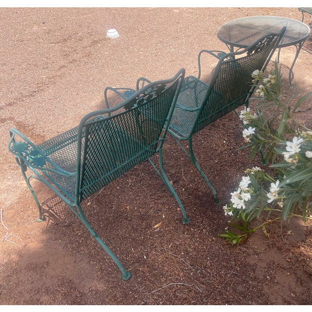 Vintage Metal Garden Chairs in Green with floral accents and curved arm rests.