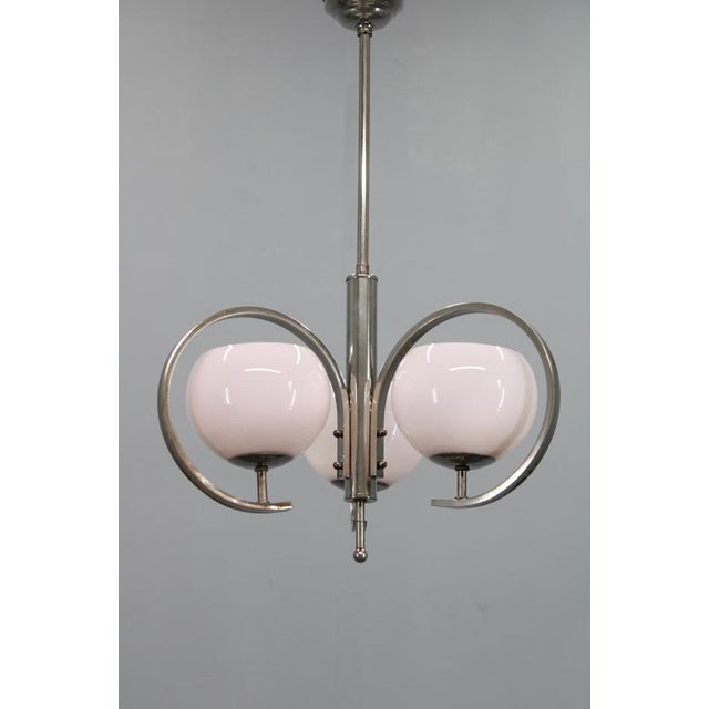 Refined art deco chandelier produced in 1930s czechoslovakia, crafted in nickel-plated metal and fitted with three light-...