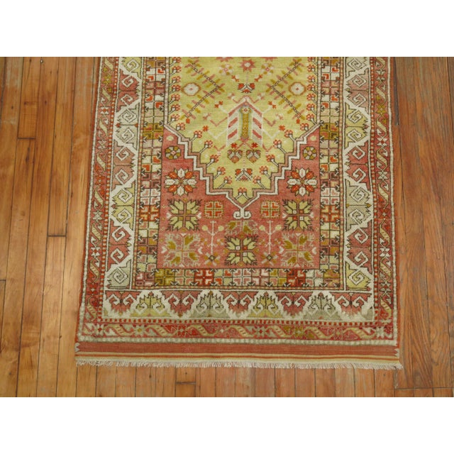 A handmade Turkish Rug with a prayer niche design in predominant colors in light greensand coral, circa 1920 Measures:...