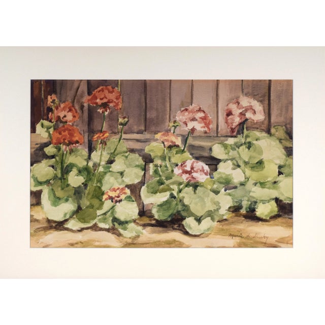 Vintage watercolor painting of flowers along a fence. Presented in cream colored matting and a gilt wood frame. Circa late...