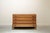 Small chest of drawers with four drawers on a black lacquered plinth made of walnut wood with double circular handles.