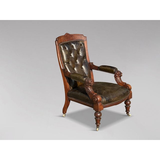 A very stylish, high-quality late 19th-century Victorian period Arts & Crafts carved walnut leather library armchair....