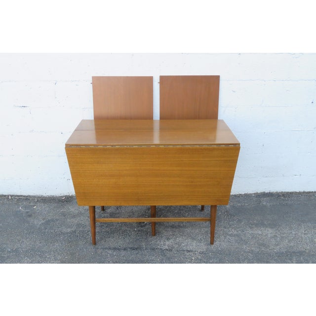 This Drop Leaf Dining Table is made out of wood, solid wood, and veneer. We believe the Table was made by Paul McCobb, due...