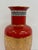 Japanese porcelain vase by Shibata featuring a deep red ground with gold floral decoration and patterned border details....