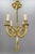 - French Louis XVI style bronze four-light bow, ribbon, and tassel chandelier from the early 20th century. - An elegant...