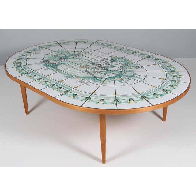 Bjørn Wiinblad coffee table with frame of pine. Table top with hand painted tiles. Signed unique table by Bjørn Wiinblad....