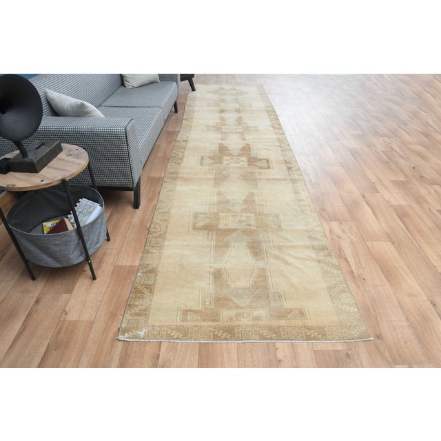 This vintage hand-knotted RUNNER rug is a semi-antique vintage area rug. The '70s Eastern region of Anatolian's unique rug...