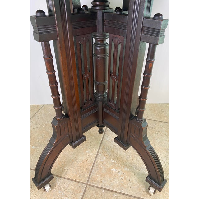 Victorian Marble Top Walnut Side Table with Ebonized Base & Original Casters, c. 1870 A beautifully sculptural Victorian...