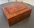 A beautifully crafted antique wooden keepsake box featuring richly figured wood and finely executed decorative inlay. The...