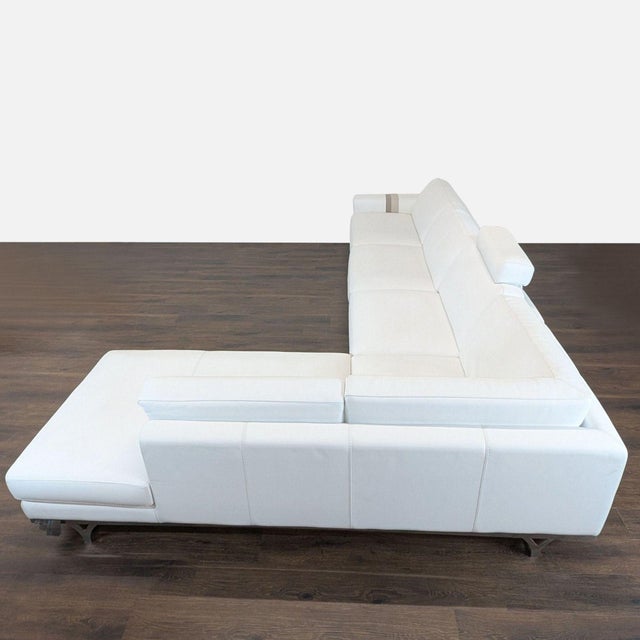 This Roche Bobois designer sectional sofa offers a clean and modern look with its white Italian leather upholstery and...