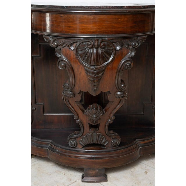 Description: Antique console table, also known as a “Pettiniera,” made of fine exotic wood and finely carved. The top,...
