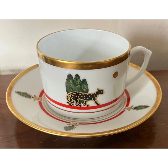 Cartier Limoges porcelain Art Deco style cup and saucer. Decorated with black panthers, parrots and topiary bushes. Saucer...
