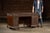 Hand-carved Indonesian hardwood kneehole desk featuring elaborate floral and foliate relief carving across the drawer...