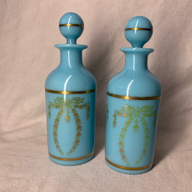 These are vintage French Portieux Vallerysthal blue opaline glass perfume bottles/decanters featuring matching stoppers...