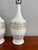 This refined pair of vintage mid-century modern table lamps features a crisp white ceramic glaze accented with original...