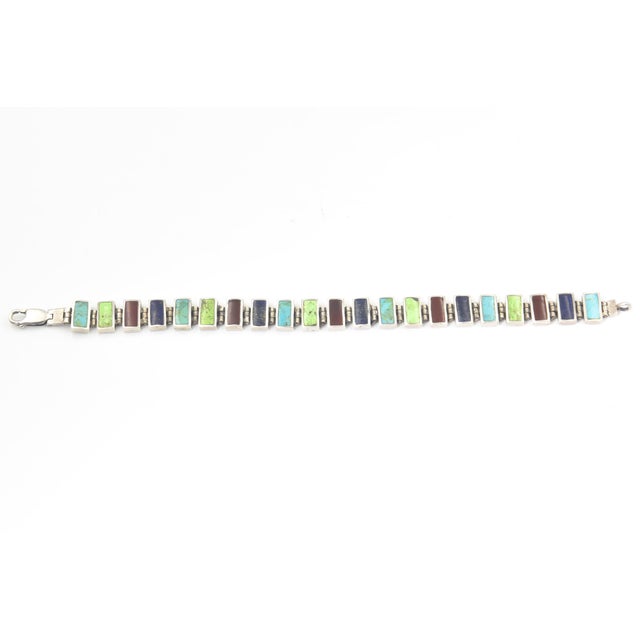 Multicolored Gemstone and Sterling Silver Link Bracelet Attractive sterling silver link bracelet featuring a vibrant array...
