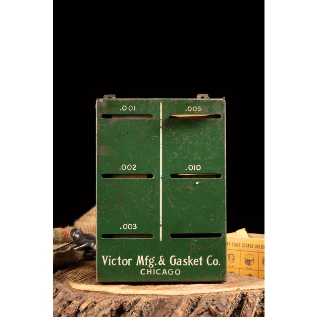 This brass flashing cabinet is constructed of metal. This cabinet was manufactured by and for the Victor Mfg. & Gasket Co....