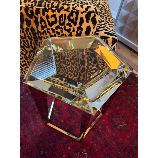 The Gem Side Table draws inspiration from the elegance of a finely cut diamond ring. Its lustrous gold legs mimic the...