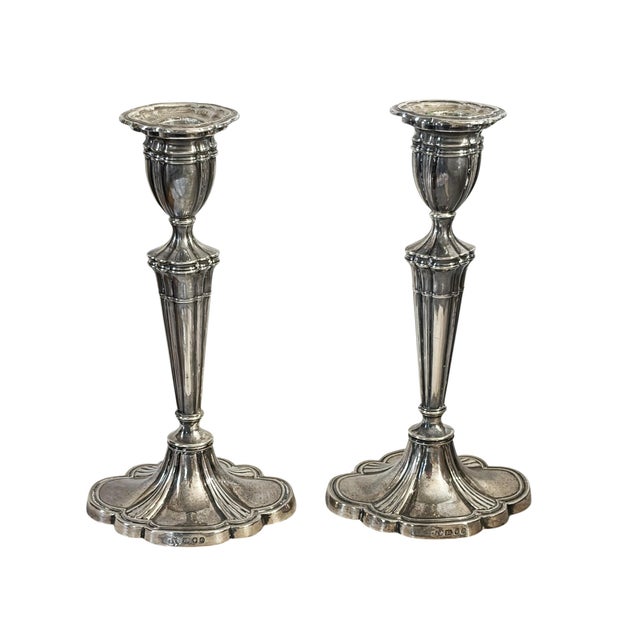 Pair of STERLING silver weighted candle holders on a sweeping, oval-cloud-shaped base, framed and profiled segments pulled...