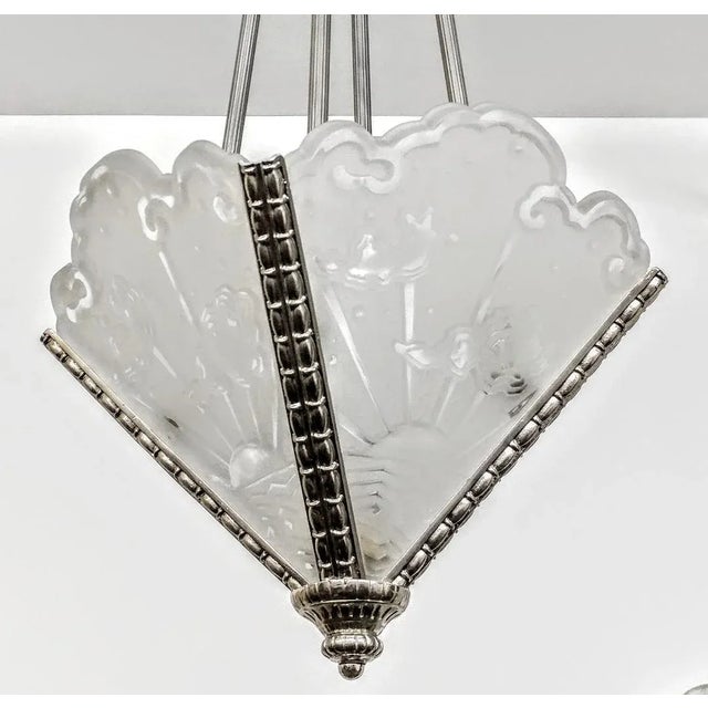 A French Art Deco chandelier by the French artist "Muller Ferers". Four panels are in clear frosted glass with a geometric...