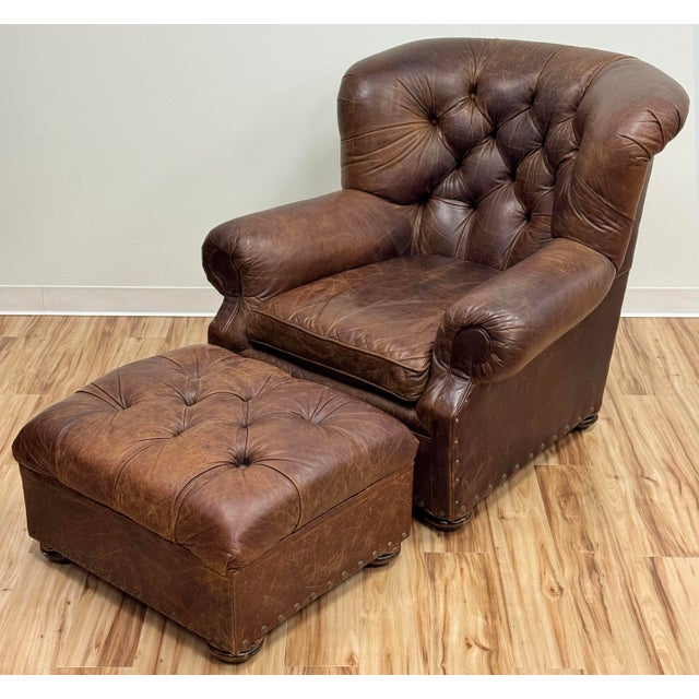 Vintage seasoned tufted leather Churchill wingback chair and matching ottoman by Restoration Hardware. Features iconic and...
