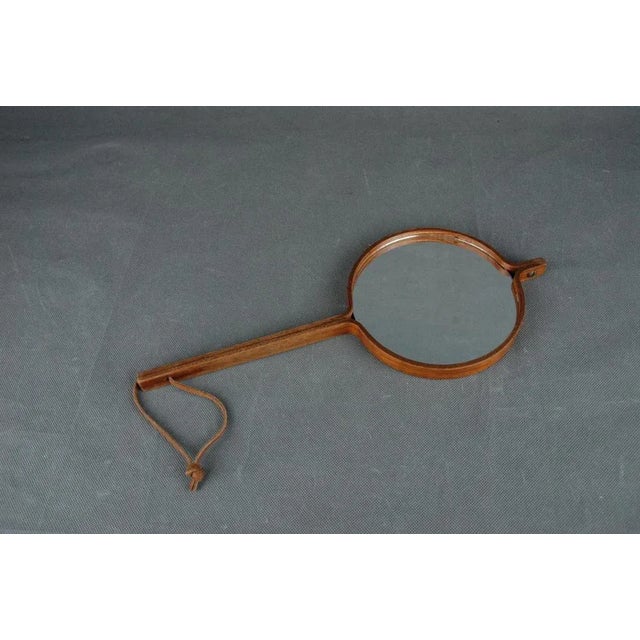 Double sided mirror can be used as a hand or wall mirror. Made of steamed Teak plywood with brass fittings and leather...