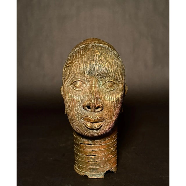 A finely cast bronze portrait head in the style of the ancient Yoruba kingdom of Ife, Nigeria. This dignified bust...