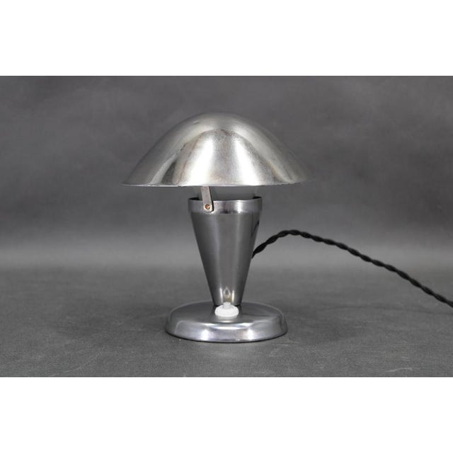 An original bauhaus mushroom table lamp with adjustable shade, produced in czechoslovakia during the 1930s. This refined...