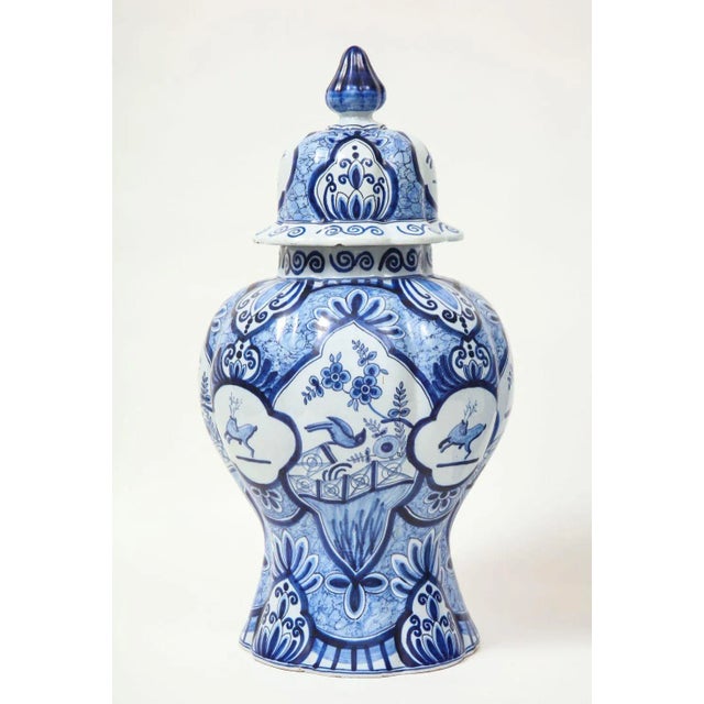 Molded with light ribbing, the covers domed with inverted acorn knops, and painted with leaping stag in quatrefoil...