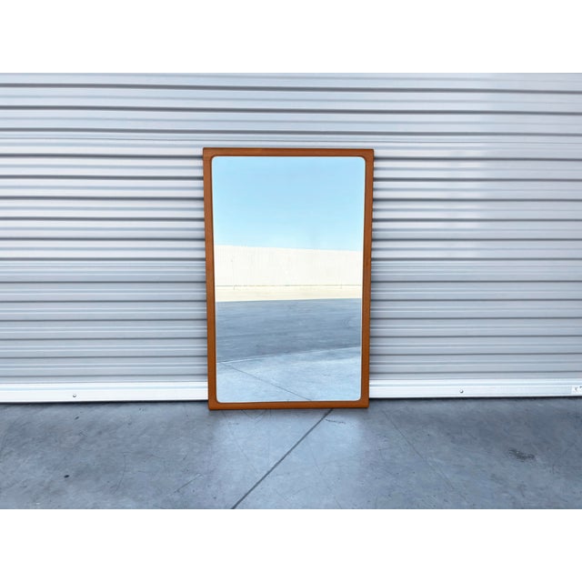 Mid-Century Modern Teak Wall Mirror by Tørring, designed by Arenkiel and manufactured in Denmark, circa 1960s. This...