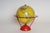 Yellow tin litho world globe produced by Replogle as part of its "Globe-Grams" series of instructional games for children...