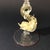 A thin, blown glass cup, finished with red edges and a dolphin-shaped stem with gold leaf inclusions. The design is by...