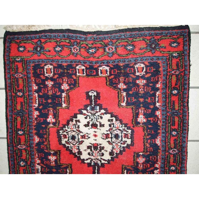 Handmade vintage Persian Hamadan rug in bright red colour. The rug is in original good condition from the end of 20th...
