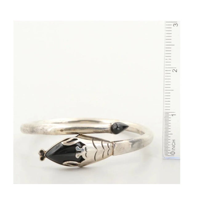 This is part of Chairish’s Fine Jewelry assortment. Exceptional 1980's Mexican Modern Sterling Silver and Obsidian Snake...