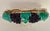 A vintage, ceramic, majolica wall pocket shaped like a vase overrunning with lush vines and blue grapes. This would be a...
