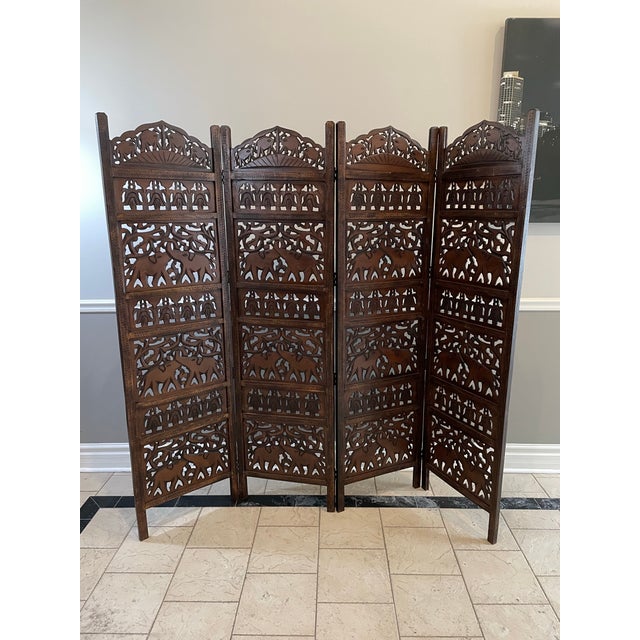 This vintage folding four piece room divider is a beautifully executed example of Southeast Asian hand-carved woodwork,...