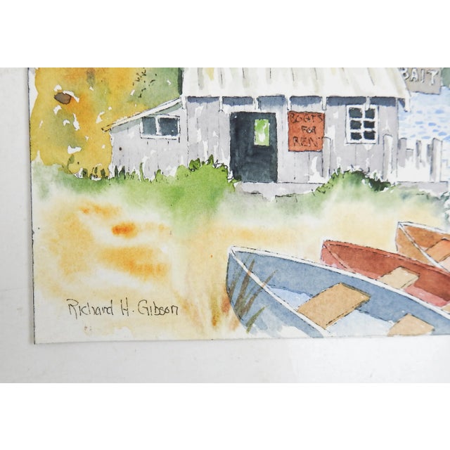 Small vintage watercolor on paper painting of lakeside bait shop and boats. Signed Richard H. Gibson lower right corner....