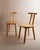 This vintage wooden chair from the 1980s features a minimalist design with light wood and a timeless form, inspired by...