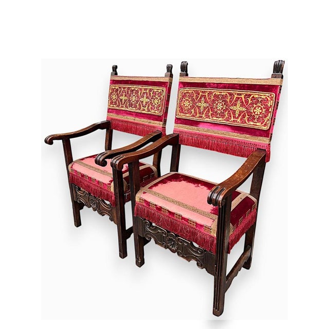 Pair of walnut armchairs, Lombard production, with carved panel and grooves that reach the legs from the armrests. Every...