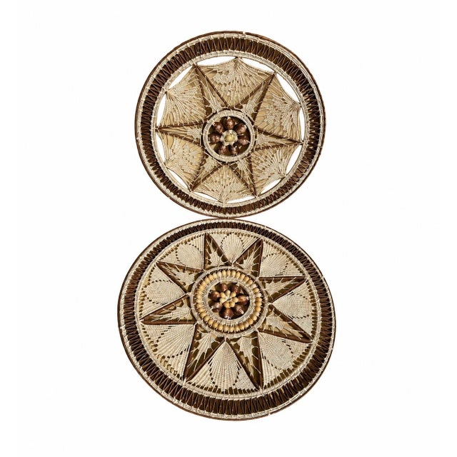 Awesome set of 2 cowrie shell round wall hangings. They are hand woven and no two are exactly alike. These make a nice...